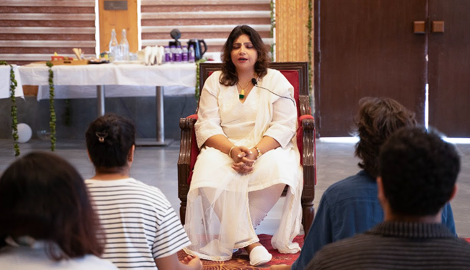 Dr. Monika in meditation, guiding the family circle