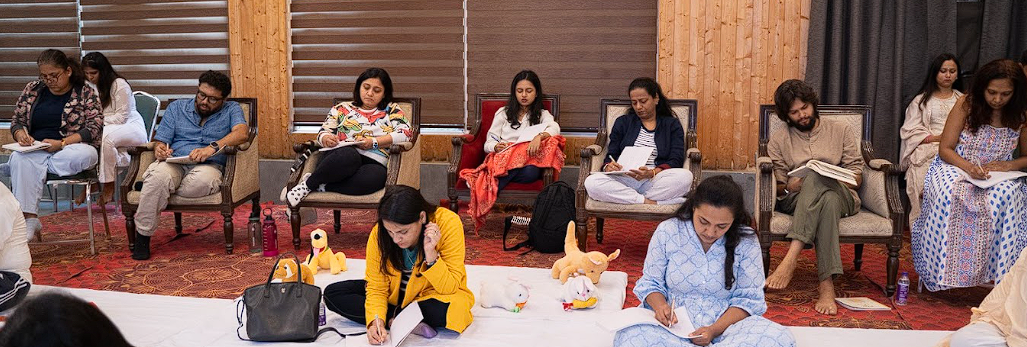 Participants journaling together in a wide sharing circle