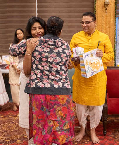 A heartfelt embrace and gifting moment between participants