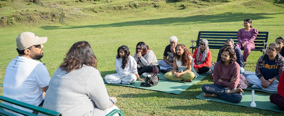 Outdoor sharing circle on the grass at sunrise