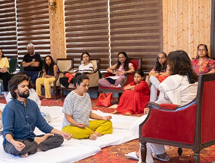 Group seated in meditation together in the retreat hall
