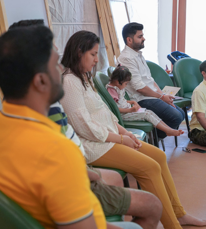Family meditating together with eyes closed
